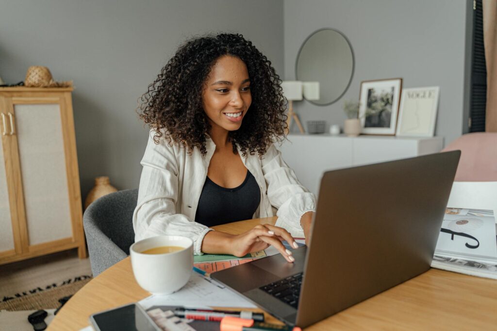 Woman using her laptop to surf the internet at home