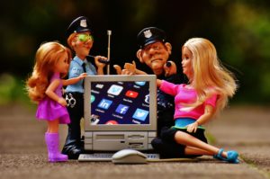 dolls surrounding toy desktop computer