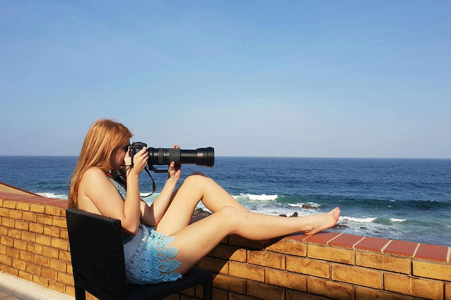A woman taking an image of the horizon.