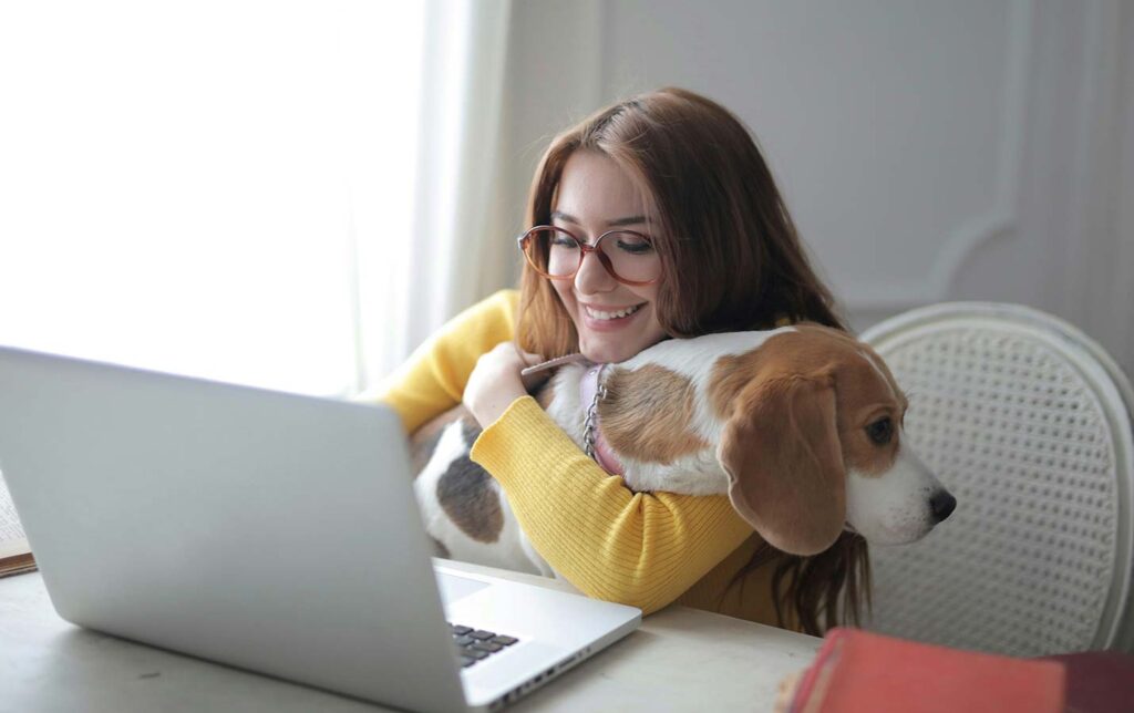 Happy woman with dog using an unlimited wireless internet plan