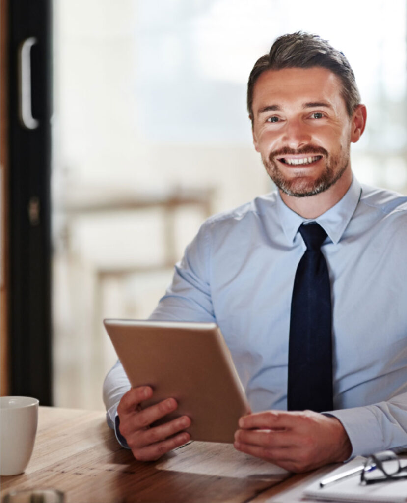 business man smiling with a tablet