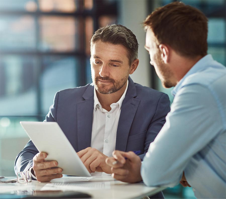 Two businessmen reviewing a tablet with 5g internet